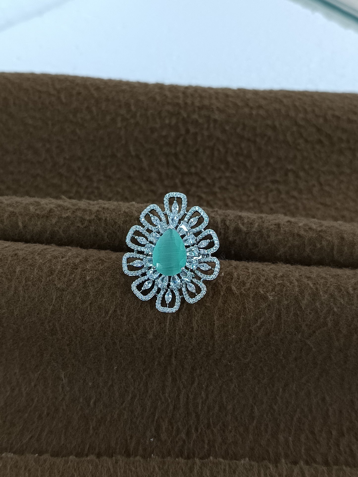 "Radiant Bloom – Premium Platinum-Plated AD Finger Ring with Pear-Cut Center Gemstone"