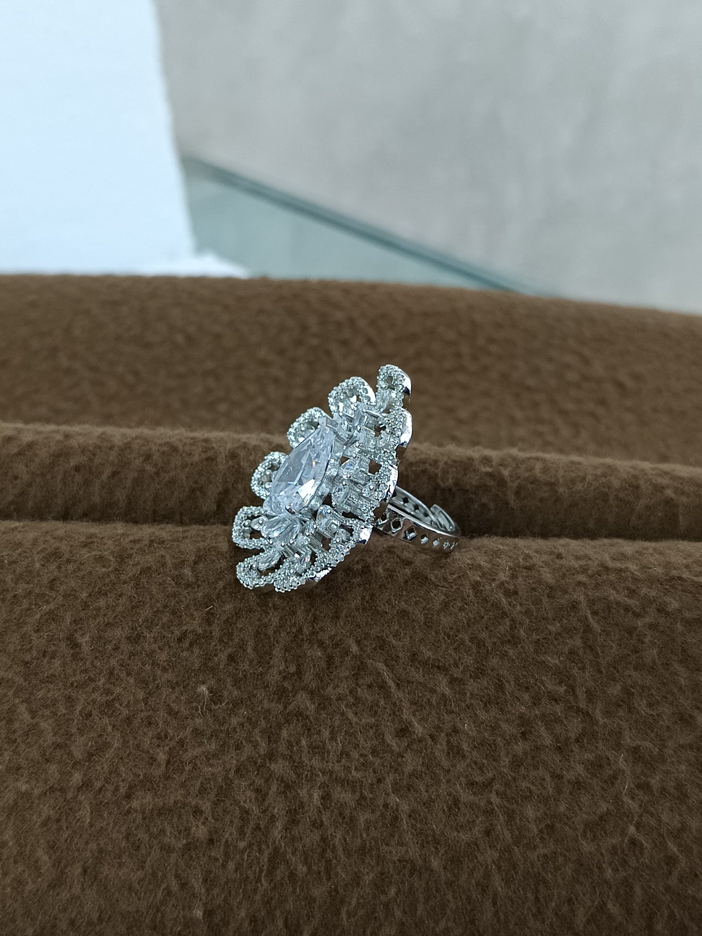"Radiant Bloom – Premium Platinum-Plated AD Finger Ring with Pear-Cut Center Gemstone"