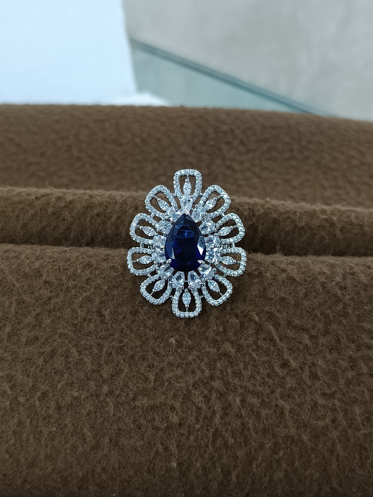 "Radiant Bloom – Premium Platinum-Plated AD Finger Ring with Pear-Cut Center Gemstone"