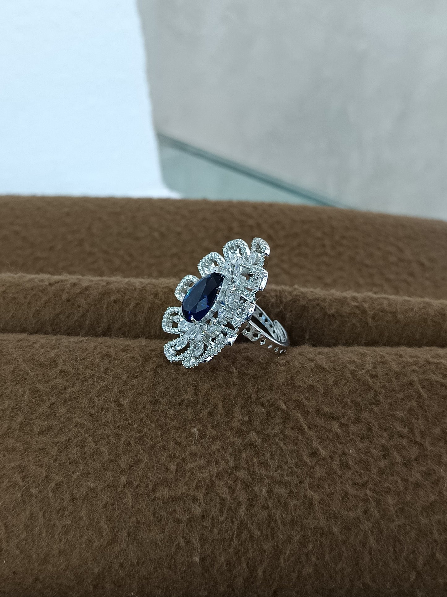 "Radiant Bloom – Premium Platinum-Plated AD Finger Ring with Pear-Cut Center Gemstone"