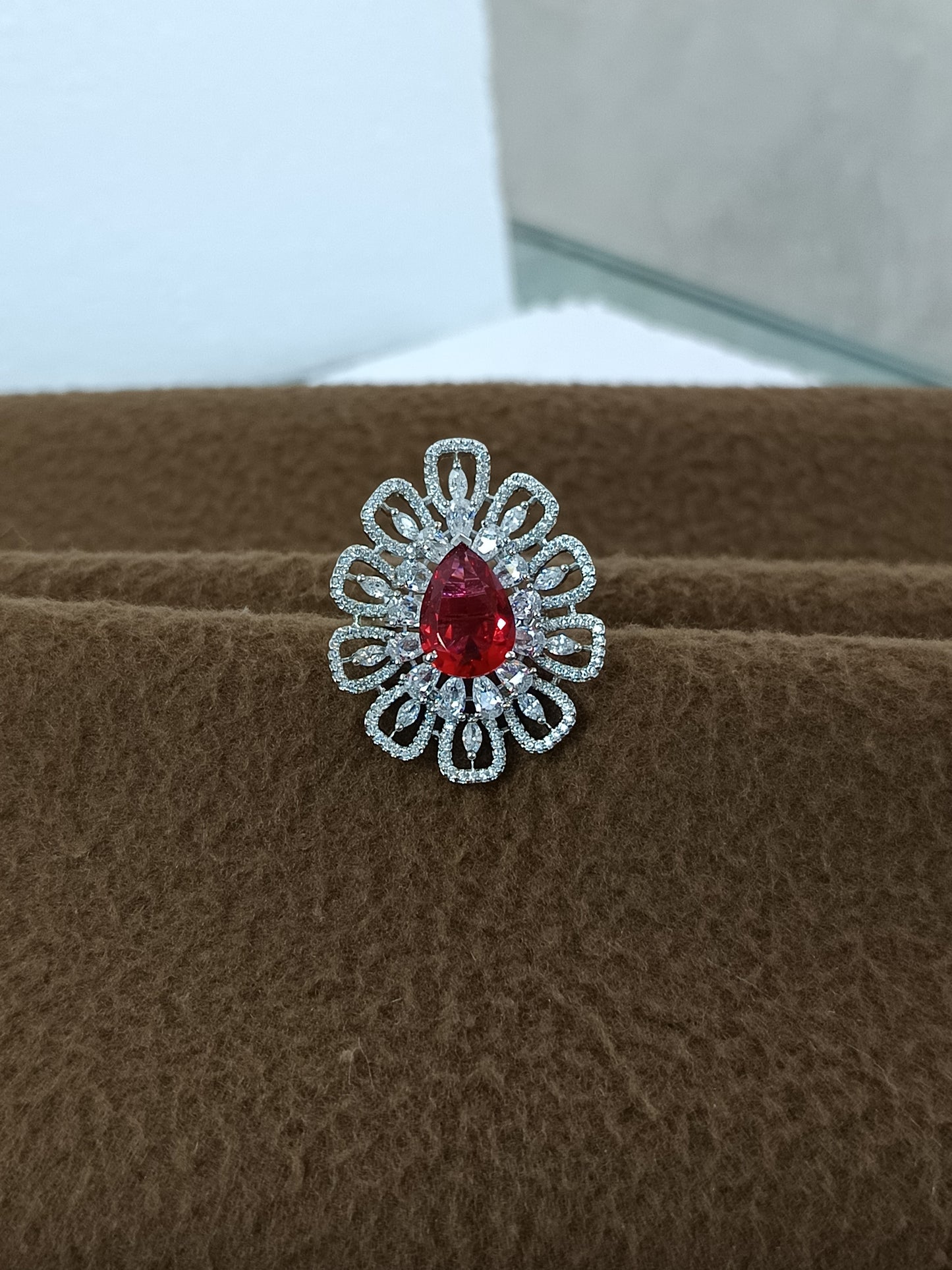 "Radiant Bloom – Premium Platinum-Plated AD Finger Ring with Pear-Cut Center Gemstone"