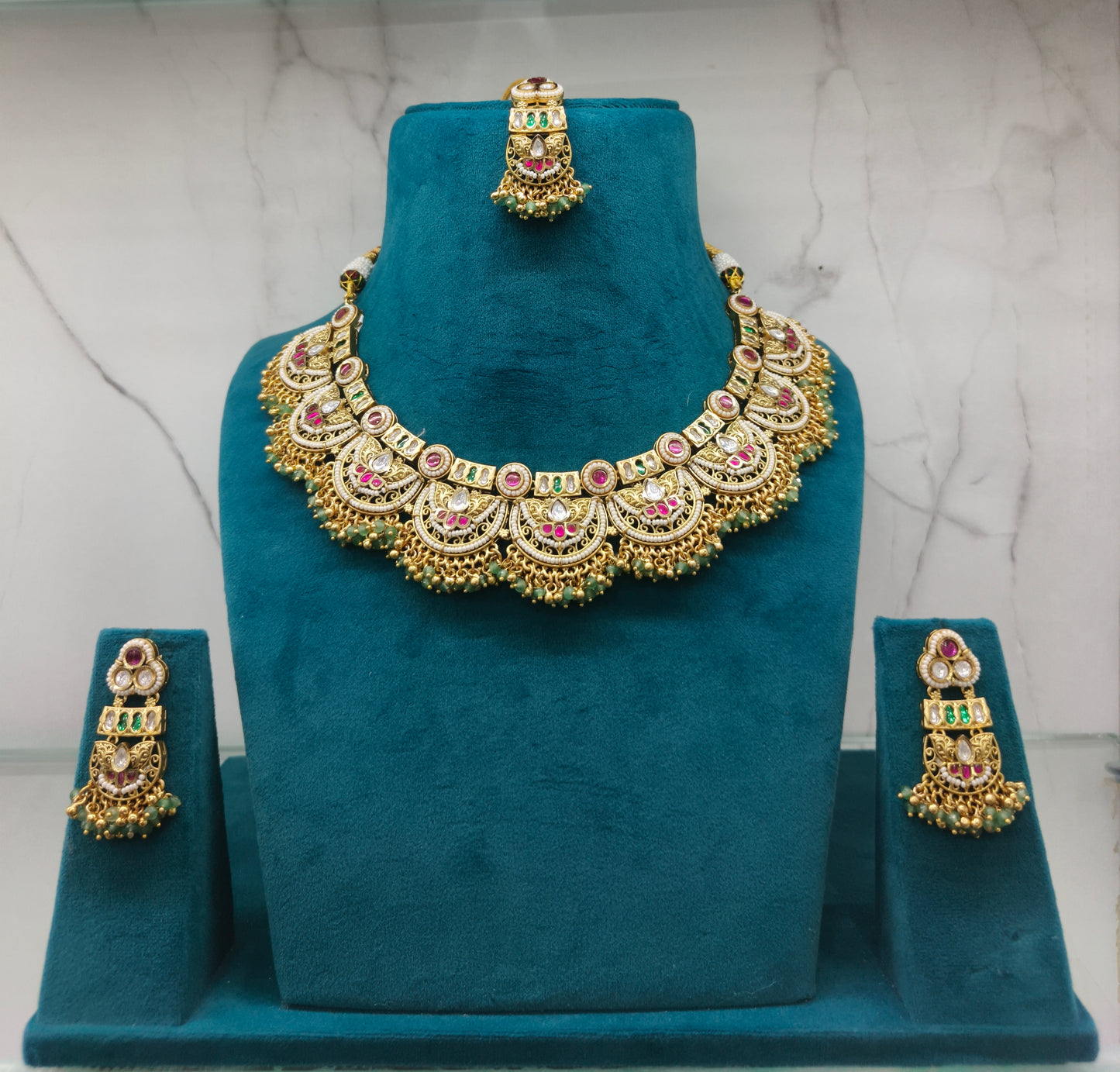 Gold necklace with pink stones and matching earrings
