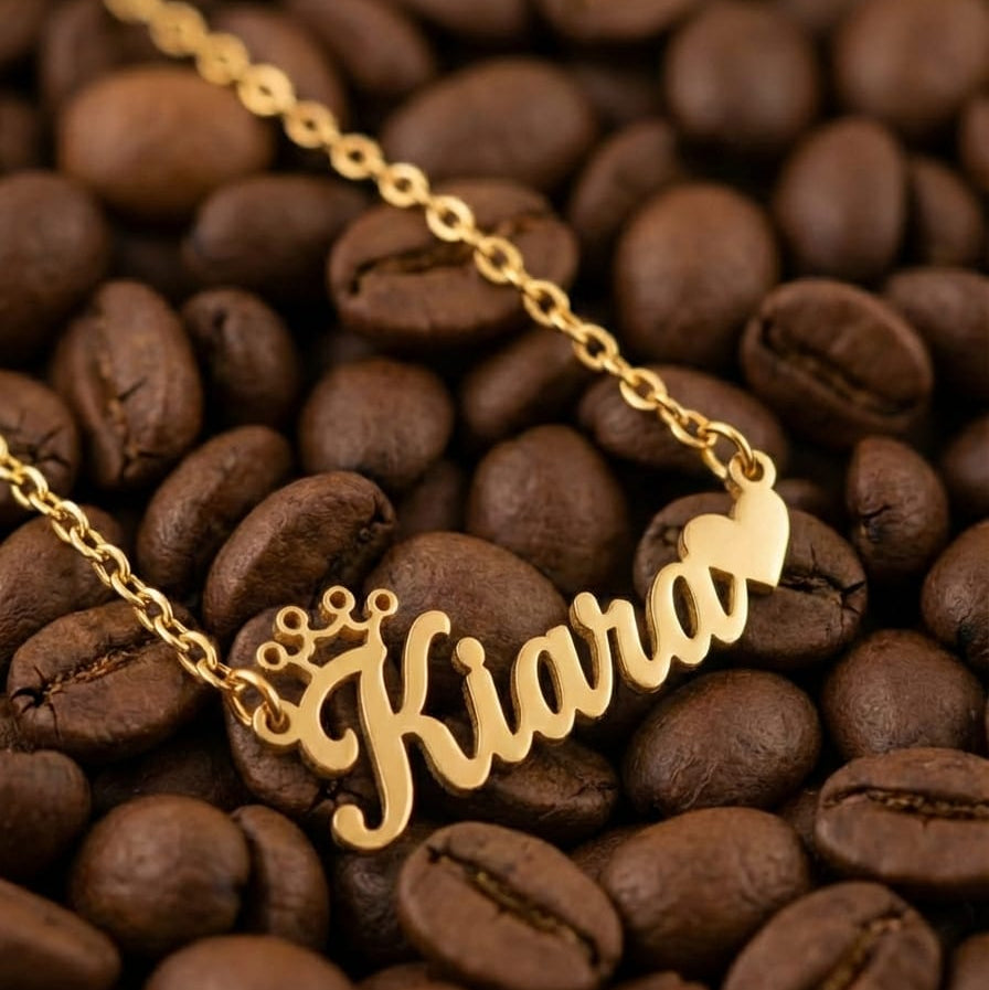 Gold necklace with 'Kiara' pendant on coffee beans