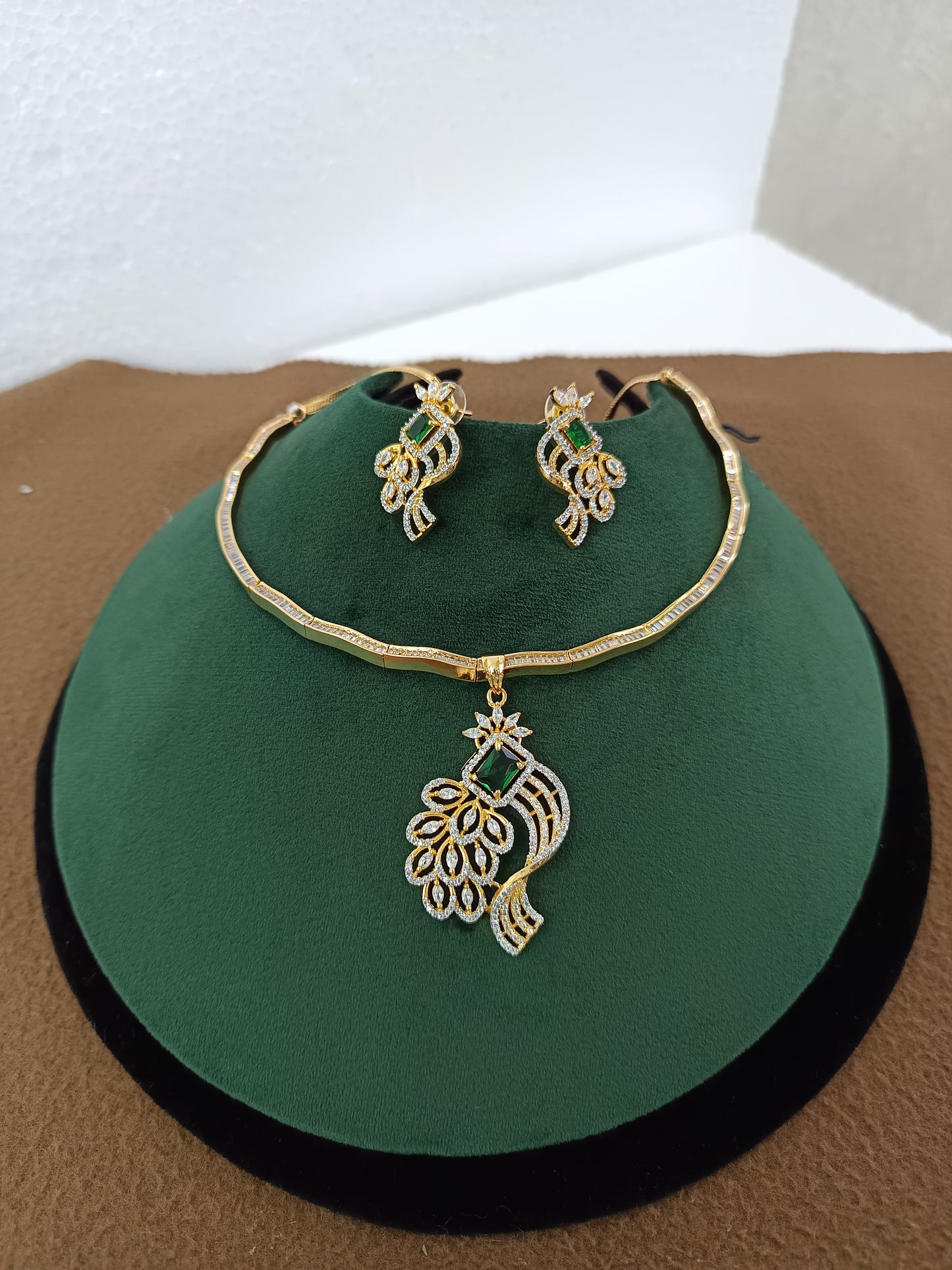 Peacock Elegance – Gold & Rhodium-Plated American Diamond Pendant Set with Green Stone Accent