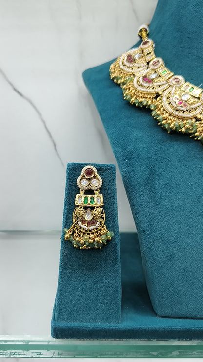 Gold necklace with pink stones and matching earrings