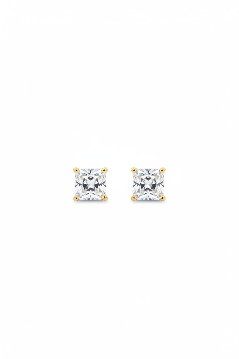 Pair of delicate gold-plated princess cut square solitaire stud earrings displayed on a premium black cloth background.