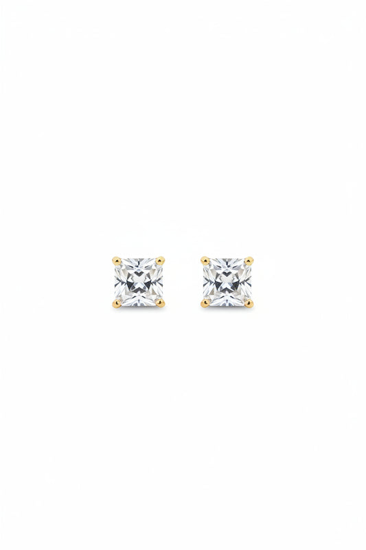Pair of delicate gold-plated princess cut square solitaire stud earrings displayed on a premium black cloth background.