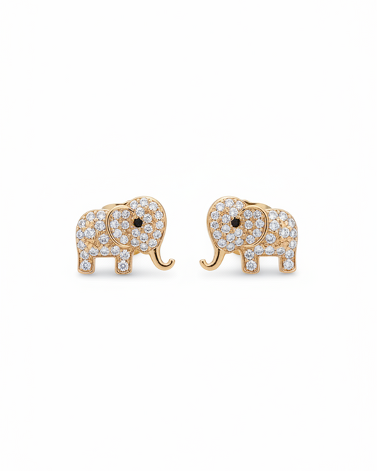 A pair of gold-plated elephant stud earrings fully encrusted with brilliant white cubic zirconia stones, displayed beautifully on a black fabric background.