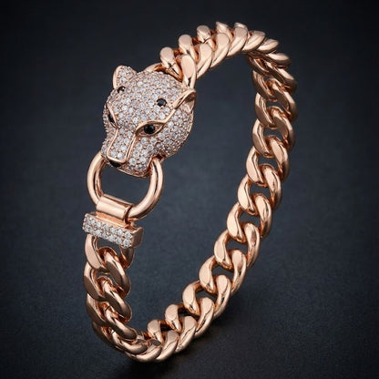 Rose gold bracelet with panther head design on a dark background