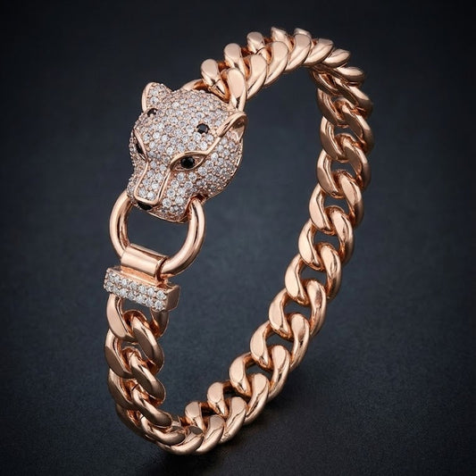 Rose gold bracelet with panther head design on a dark background